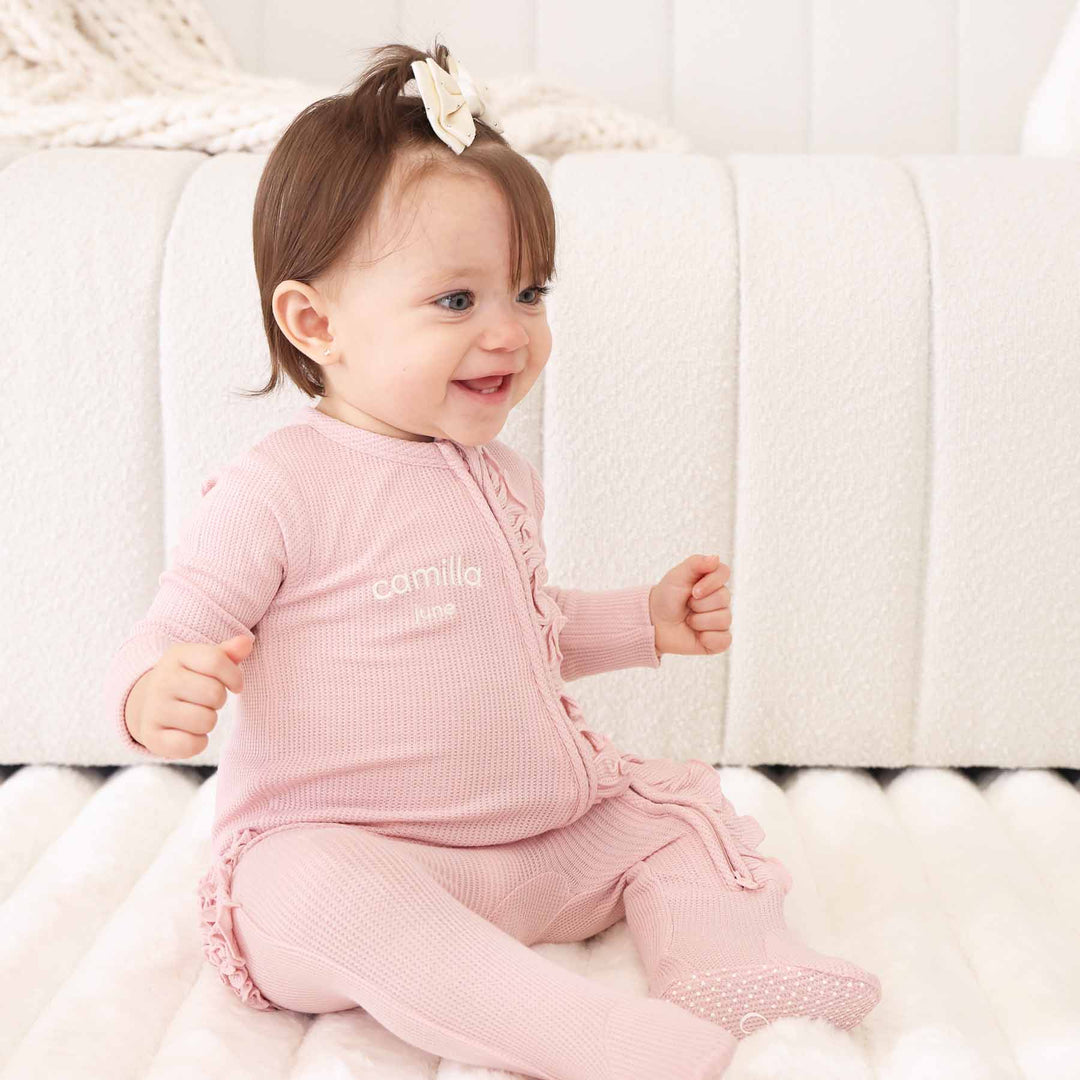light pink bamboo waffle zipper ruffle footie embroidered with name 