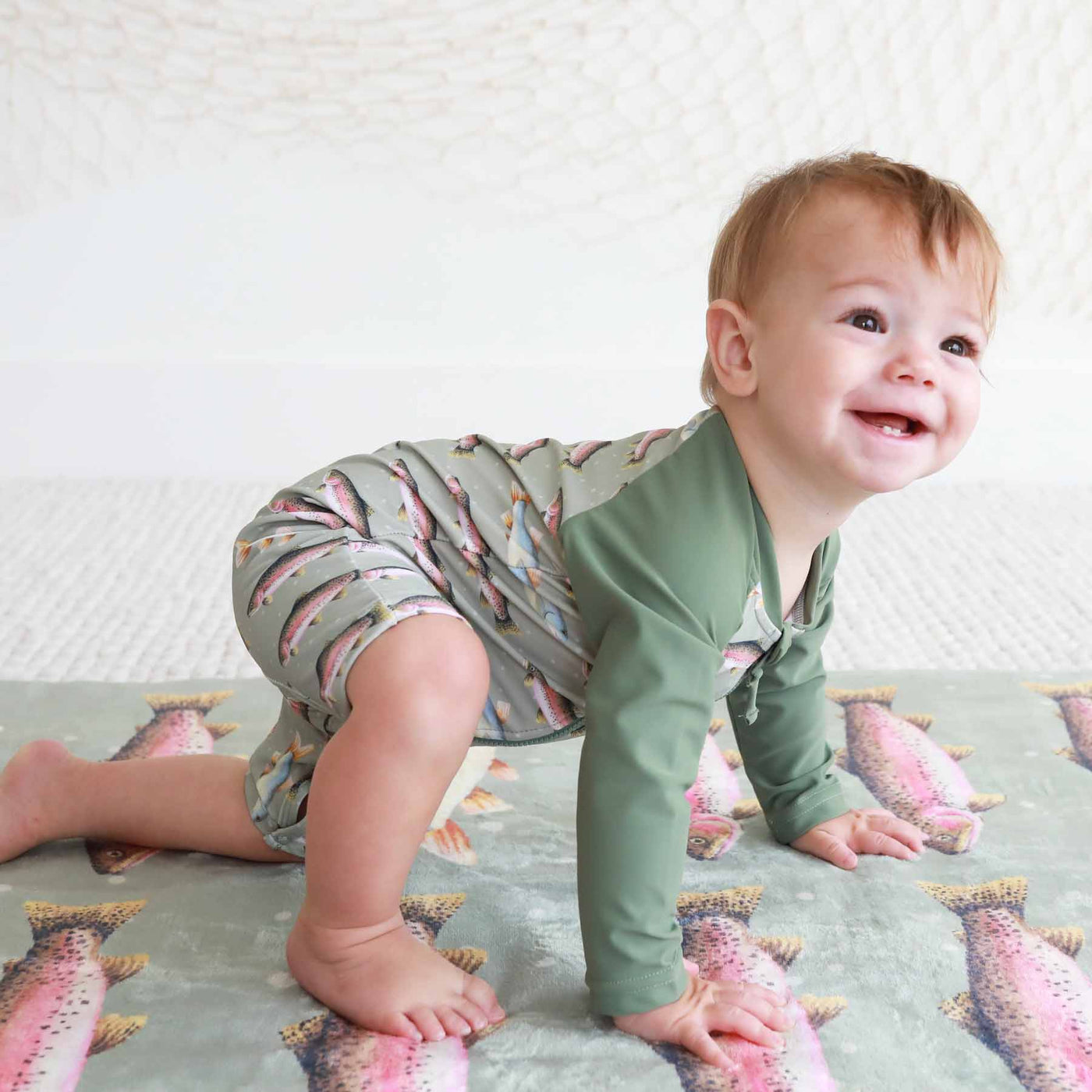 green swim romper for boys with trout 