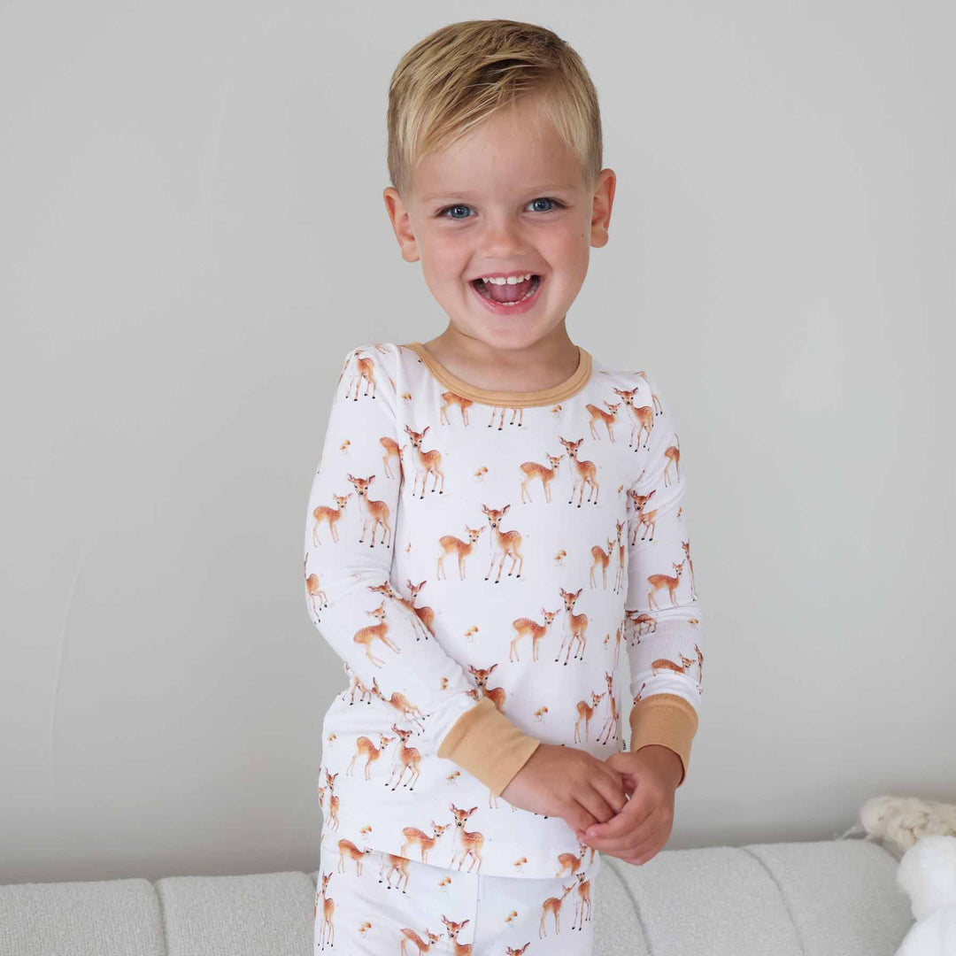 Happy boy in woodland fawn print pajamas 
