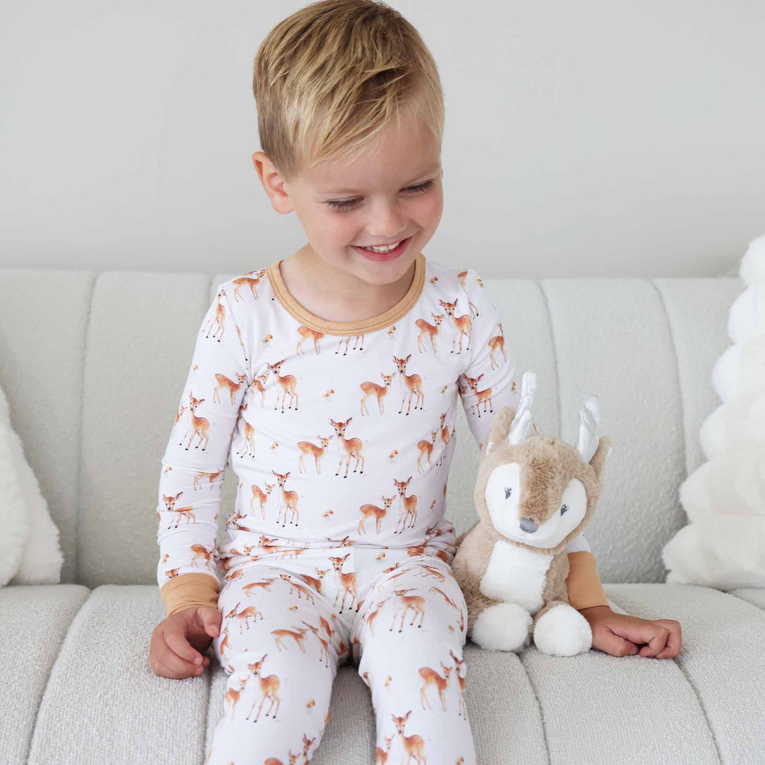 boy wearing fawn two piece pajama set 