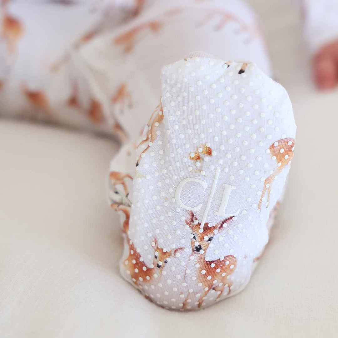 fawn baby zipper footie with grippers on the feet