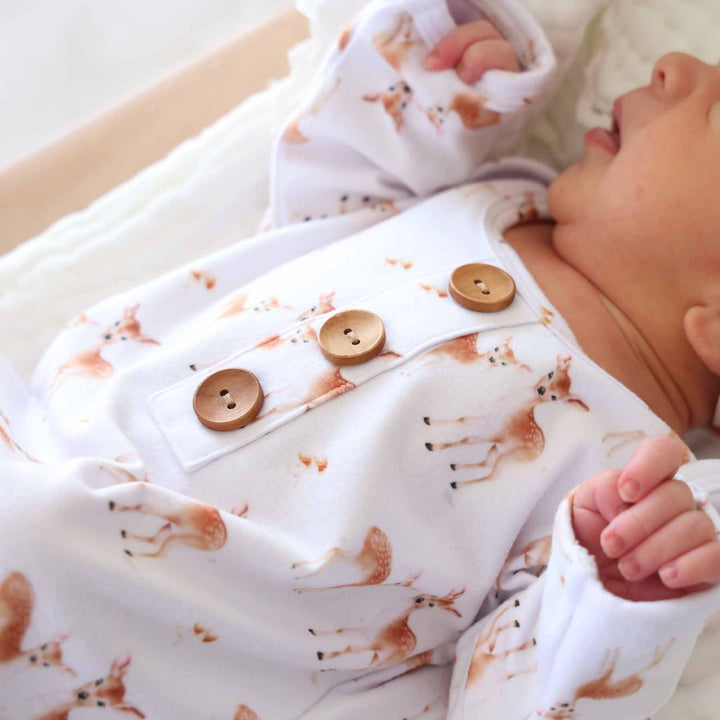white knot gown with fawns and three wooden buttons on the front 