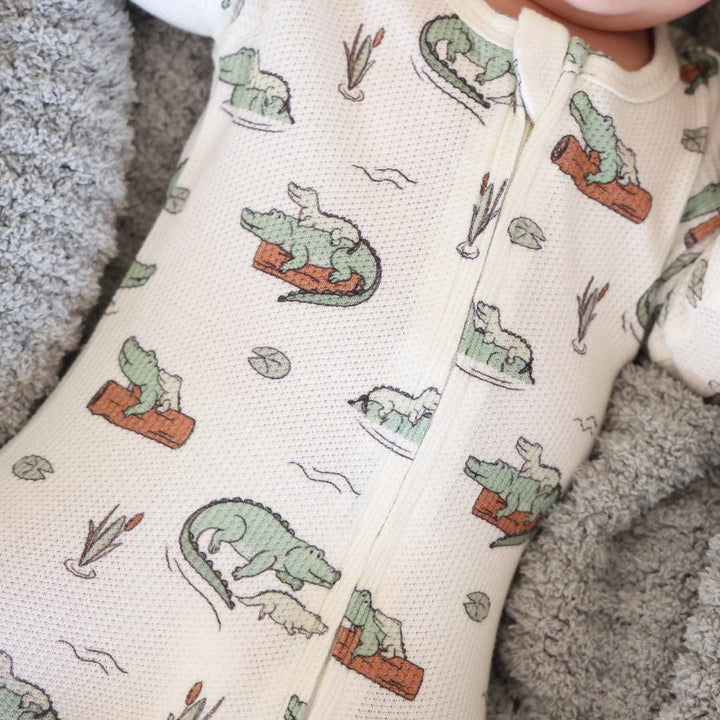 bamboo waffle zipper footie for baby boys with alligators floating on a log and lily pads