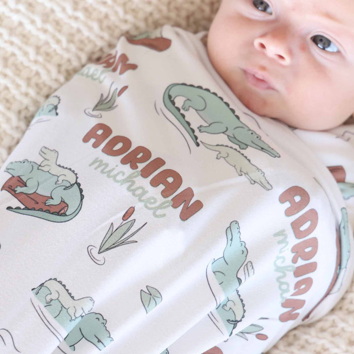 alligator floating on a log personalized baby swaddle blanket 