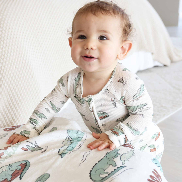 convertible zip romper pajama for baby and toddler boys with alligators floating on logs, lily pads and cat tails