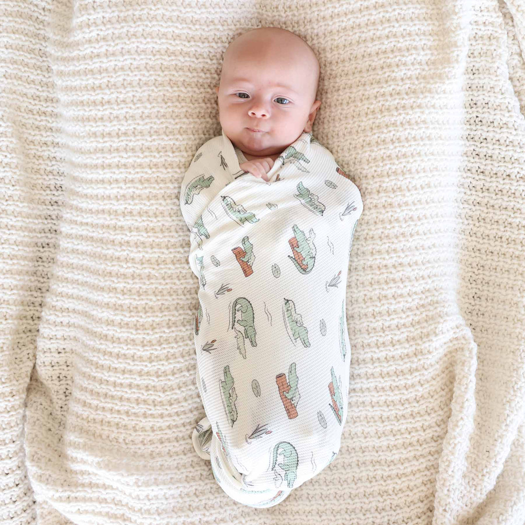 baby boy wrapped in bamboo waffle alligator swaddle
