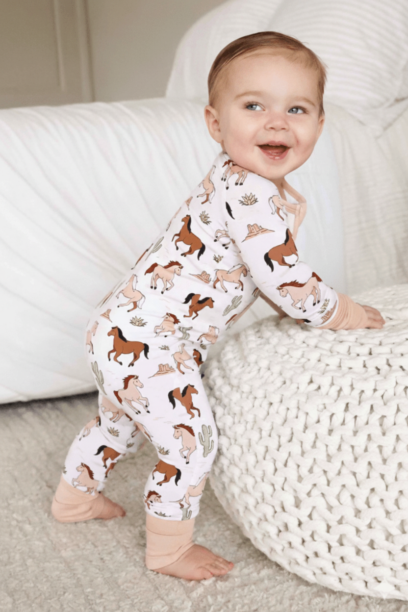 standing baby boy in pony club convertible zip romper 