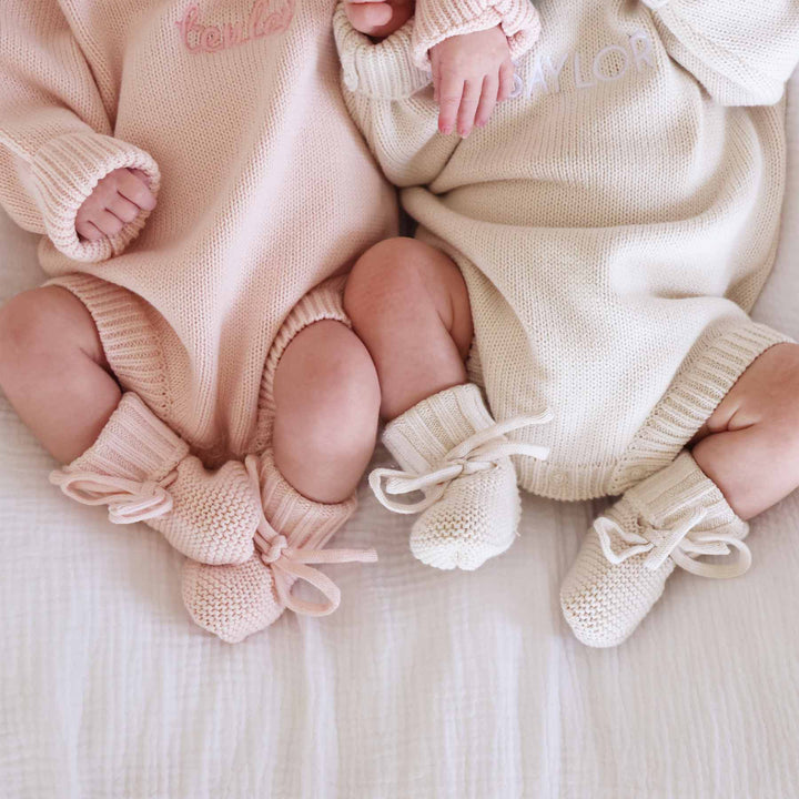 light pink and beige embroidered knit sweater rompers with matching booties 