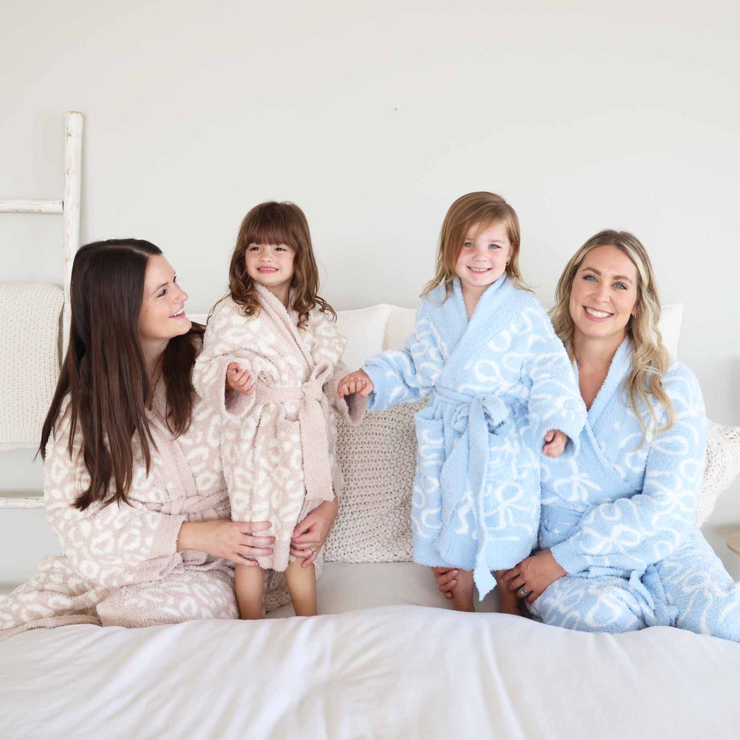 mom and daughter matching plush robes in neutral leopard and blue and white bows 