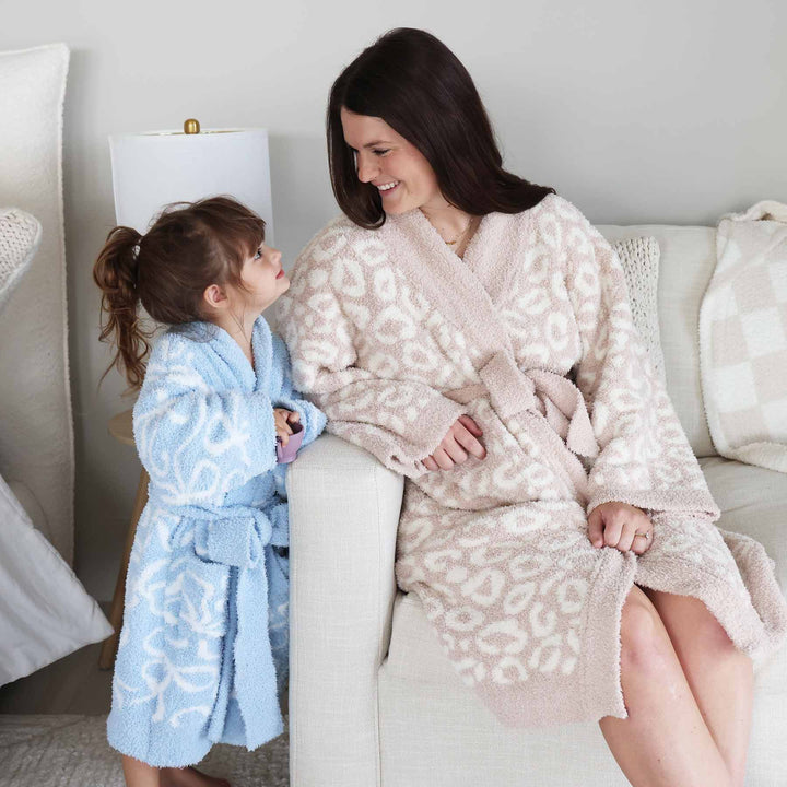 mom wearing a neutral plush robe with girl wearing a light blue and white bowrobe