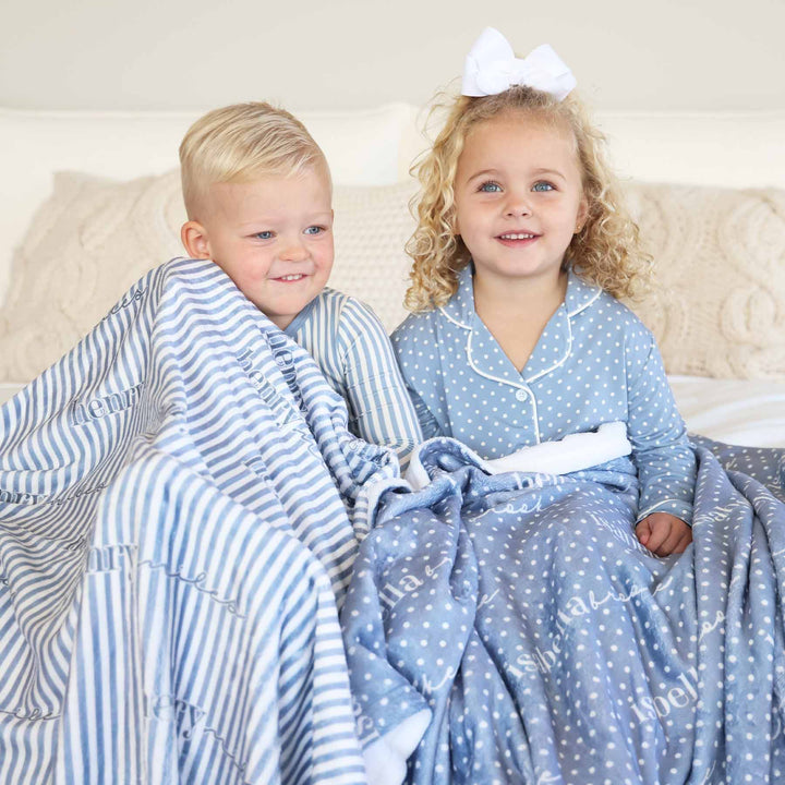 blue and white polka dot and stripe sibling matching pajamas with matching personalized blankets 