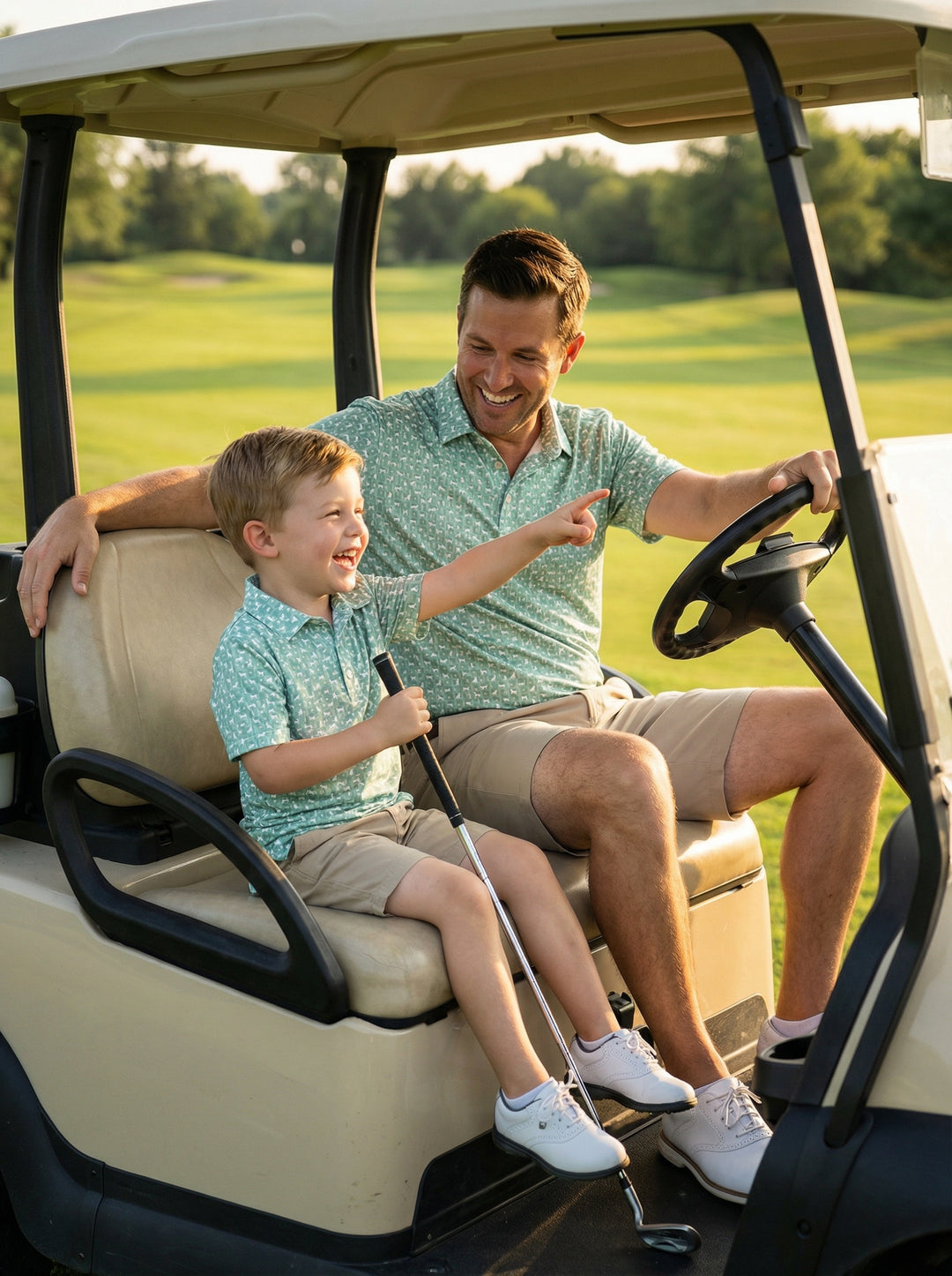 father and son riding on golf cart in matching dog golf shirts 