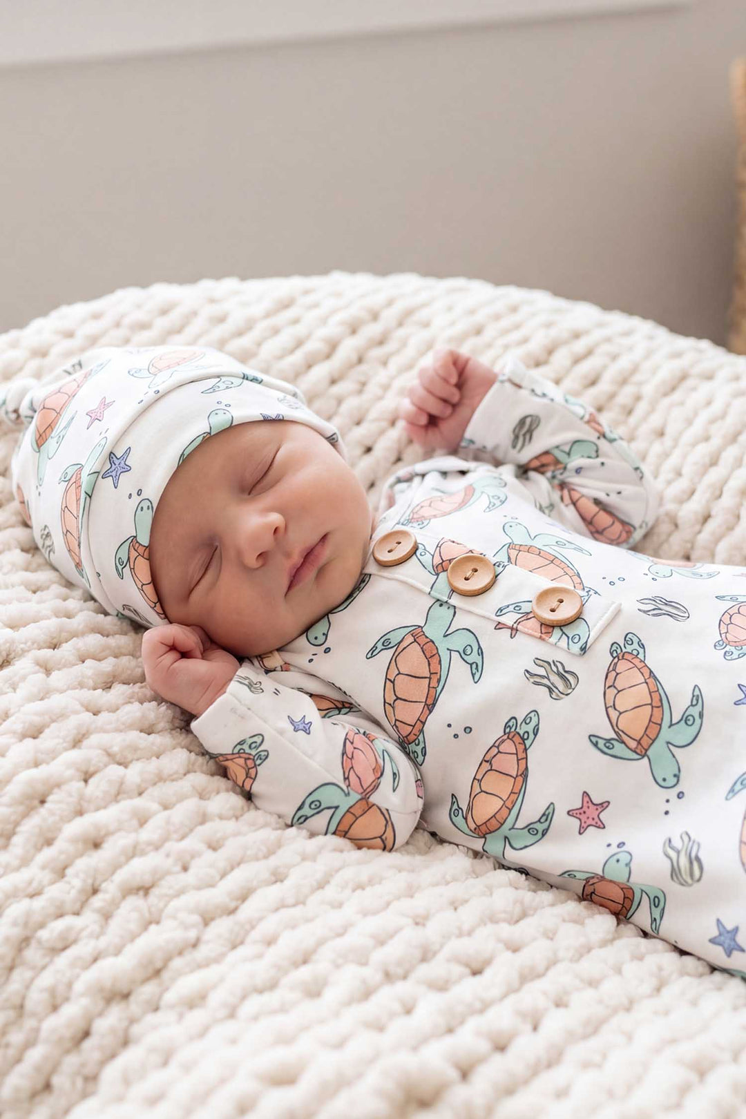 closeup of baby boy in turtle knot gown