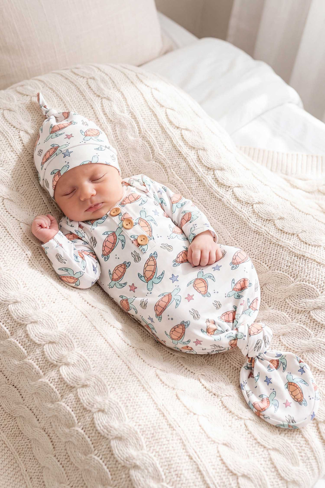 baby boy in turtle knot gown
