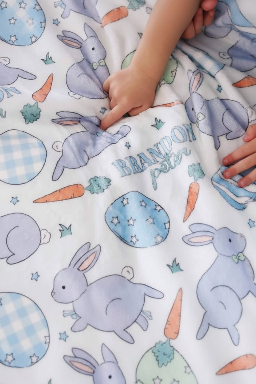 kids pointing to blue bunny on personalized easter blanket 
