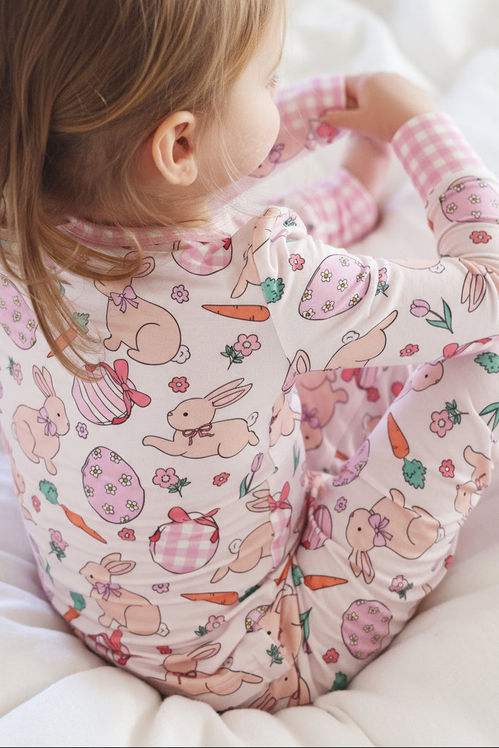 closeup of hoppy spring easter print with bunnies, easter eggs, carrots and flowers 