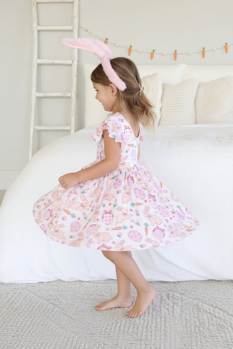 girl twirling in the pink oppy spring casual knee length dress 