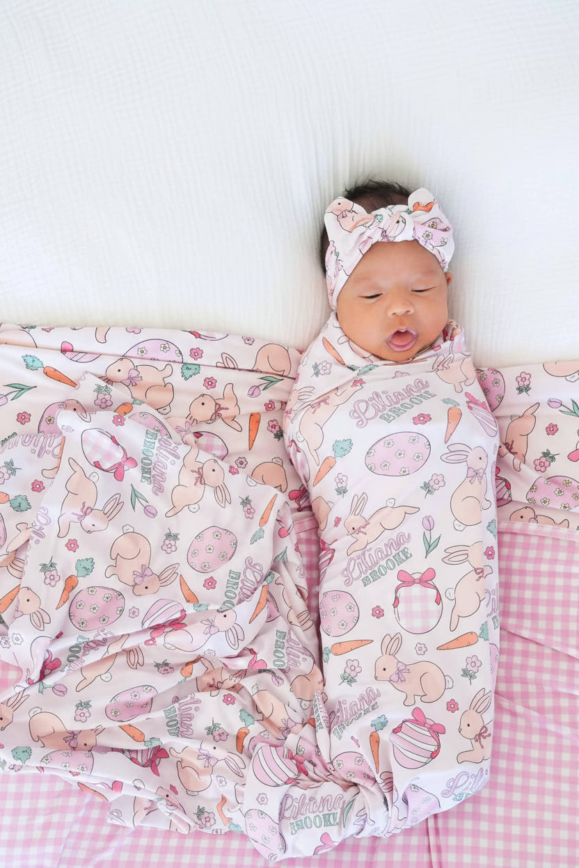 baby girl wrapped in pink easter personalized swaddle blanket 