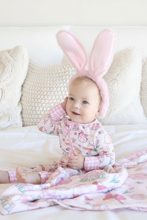 baby girl in hoppy spring convertible zip romper wearing bunny ears 
