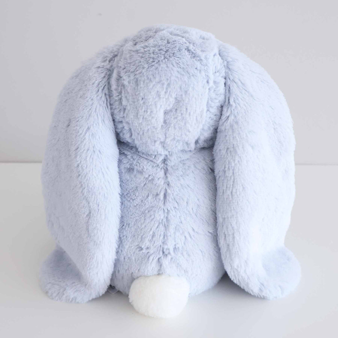 back view of light blue stuffed animal bunny with white fluffy tail