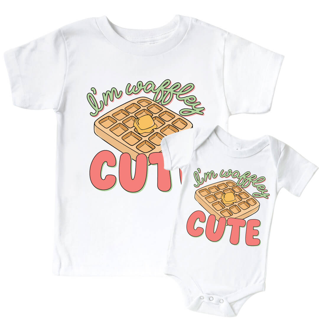 White "I'm Waffley Cute" Pink Graphic Bodysuit & Kids Tee. Green and pink color font with waffle with butter in the center.  