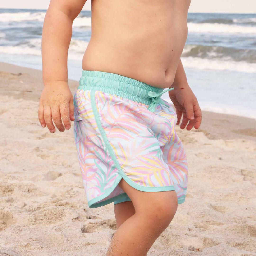 boys' swim trunks with a relaxed pastel palm leaves print and mint green accents - caden lane