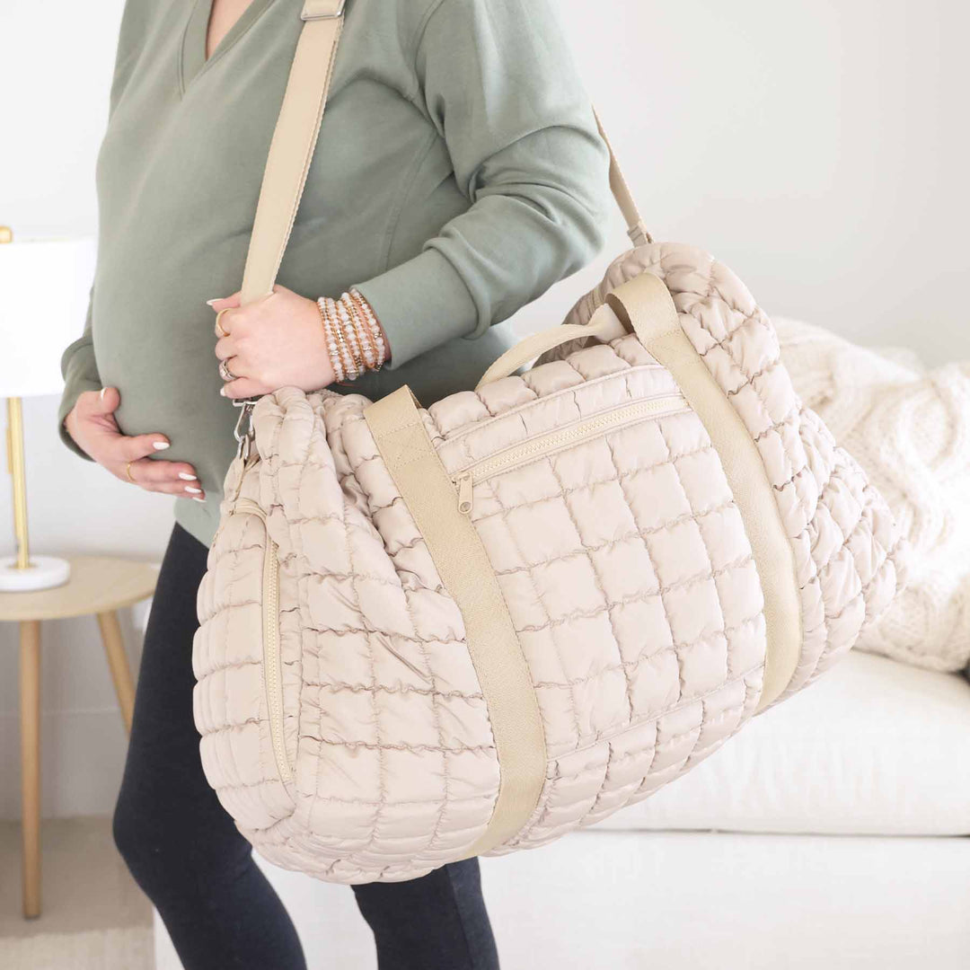 long neutral strap quilted duffel bag for women with side pockets 