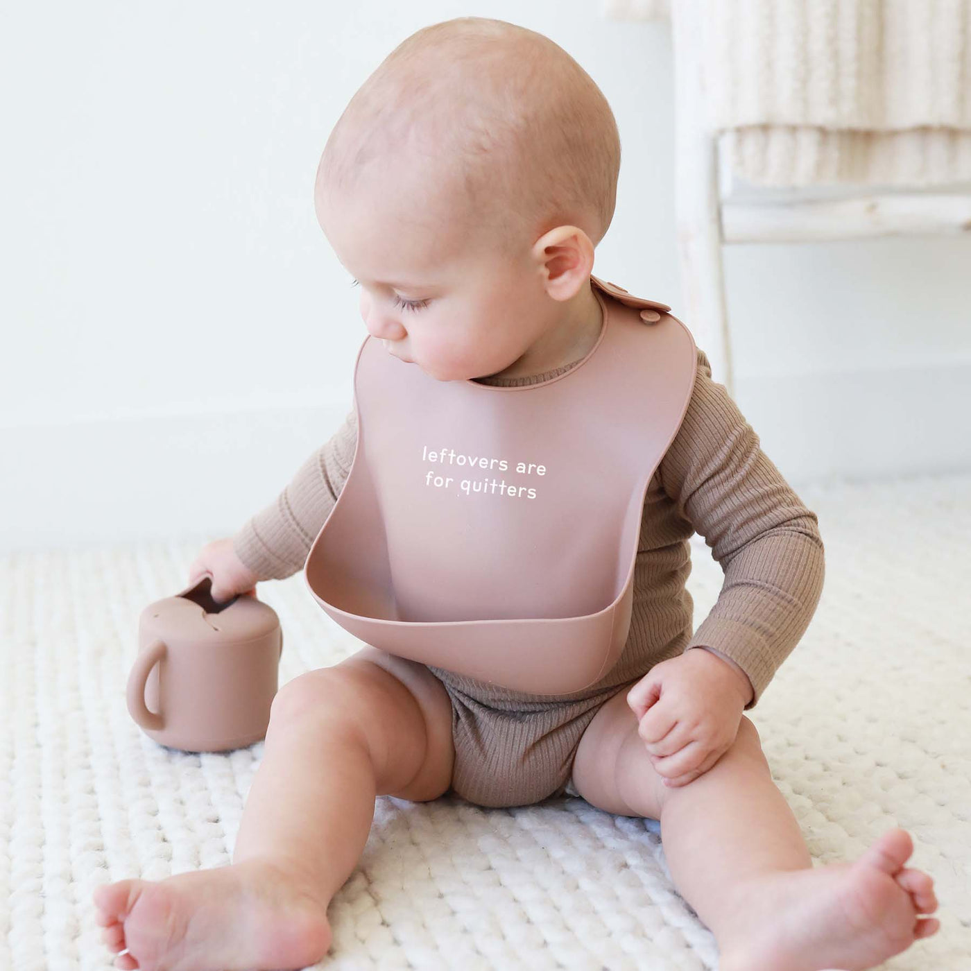 neutral baby bib with saying 