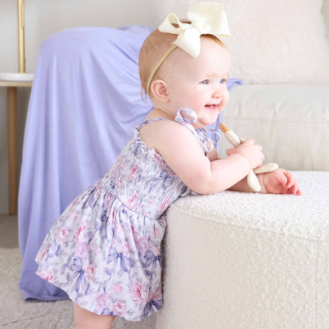 pink and purple bow and floral smocked bodysuit for babies 