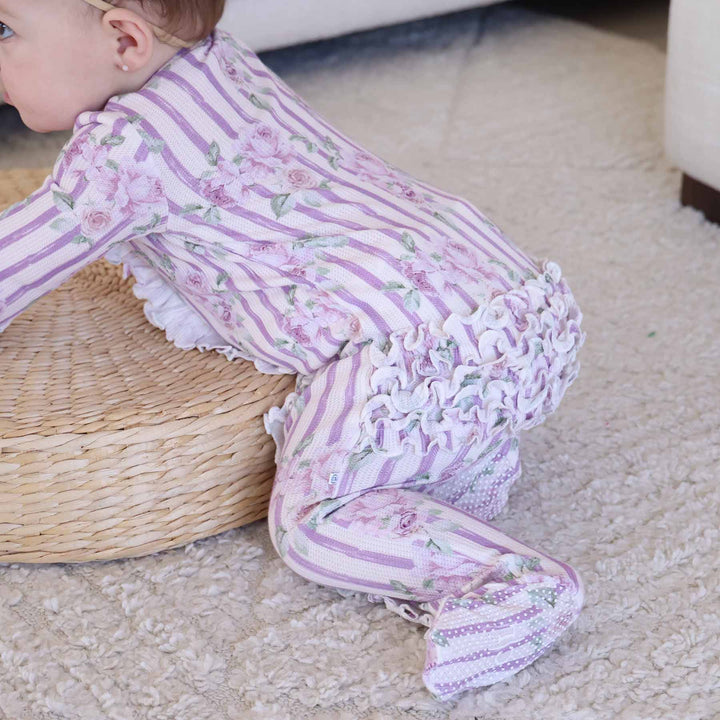 crawling baby in lila's lilacs zipper footie with ruffles on the bottom 