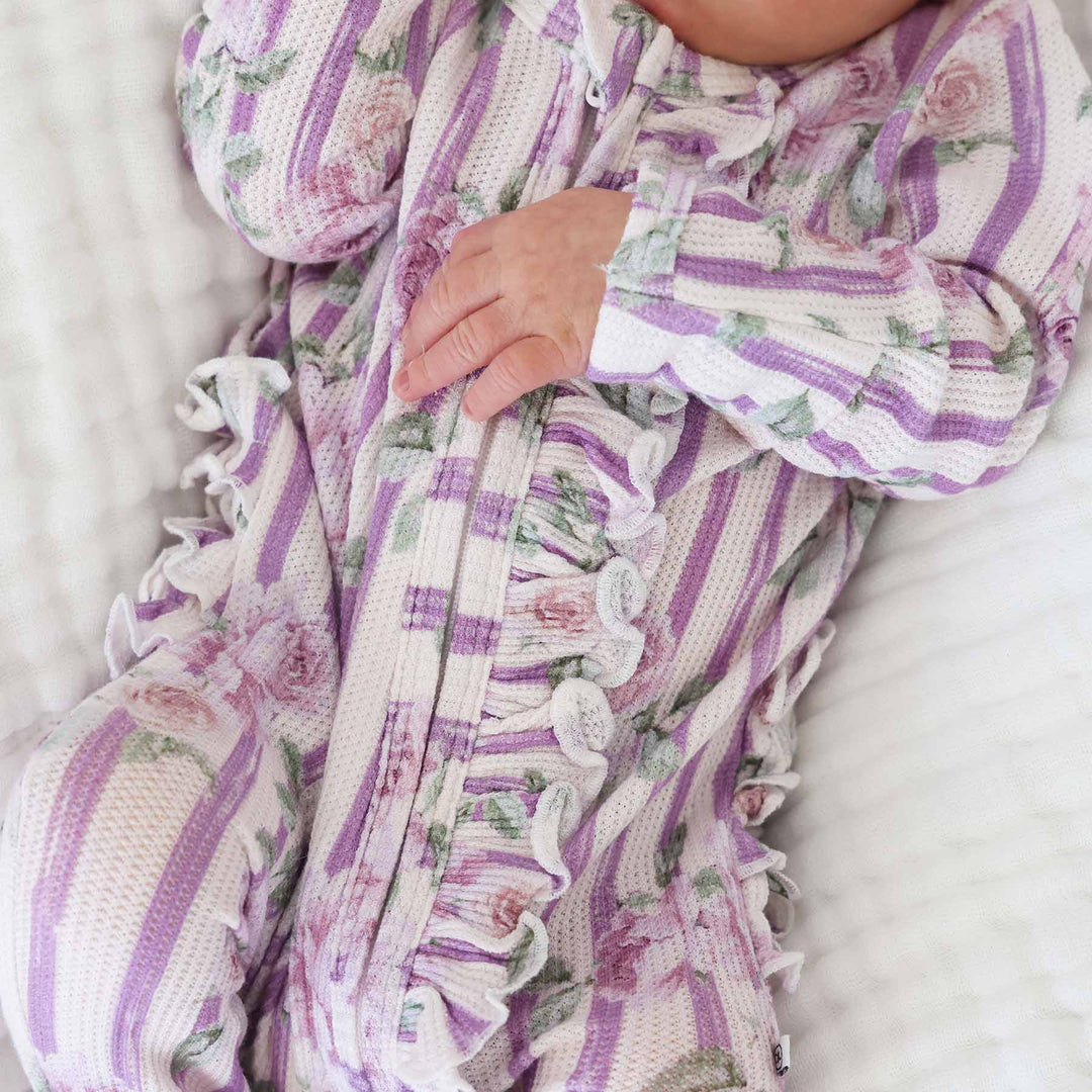 bamboo waffle zipper footie for newborn girls wit vintage purple stripes and roses with ruffles along the zipper and bottom 