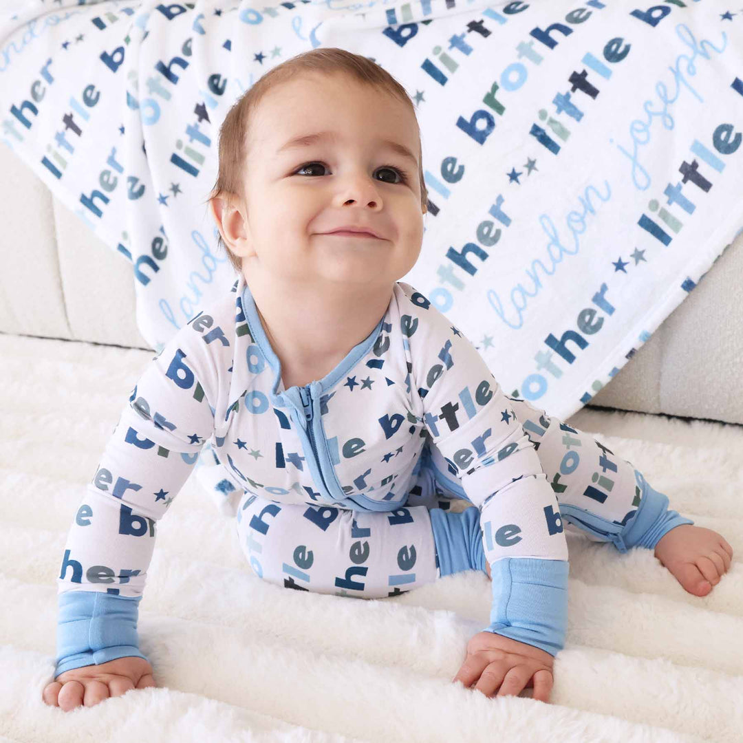 boy with matching little brother zip romper and personalized blanket