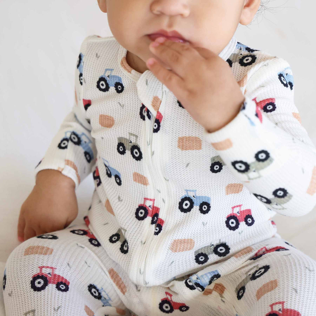 soft white and muted colorful tractor bamboo waffle baby zipper footie 