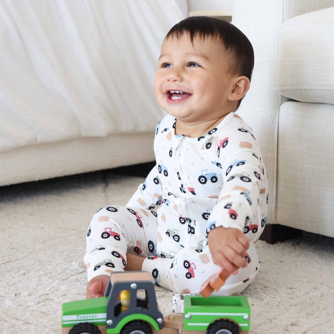 red, green and blue tractor bamboo waffle convertible zip romper pajama for babies and toddlers 