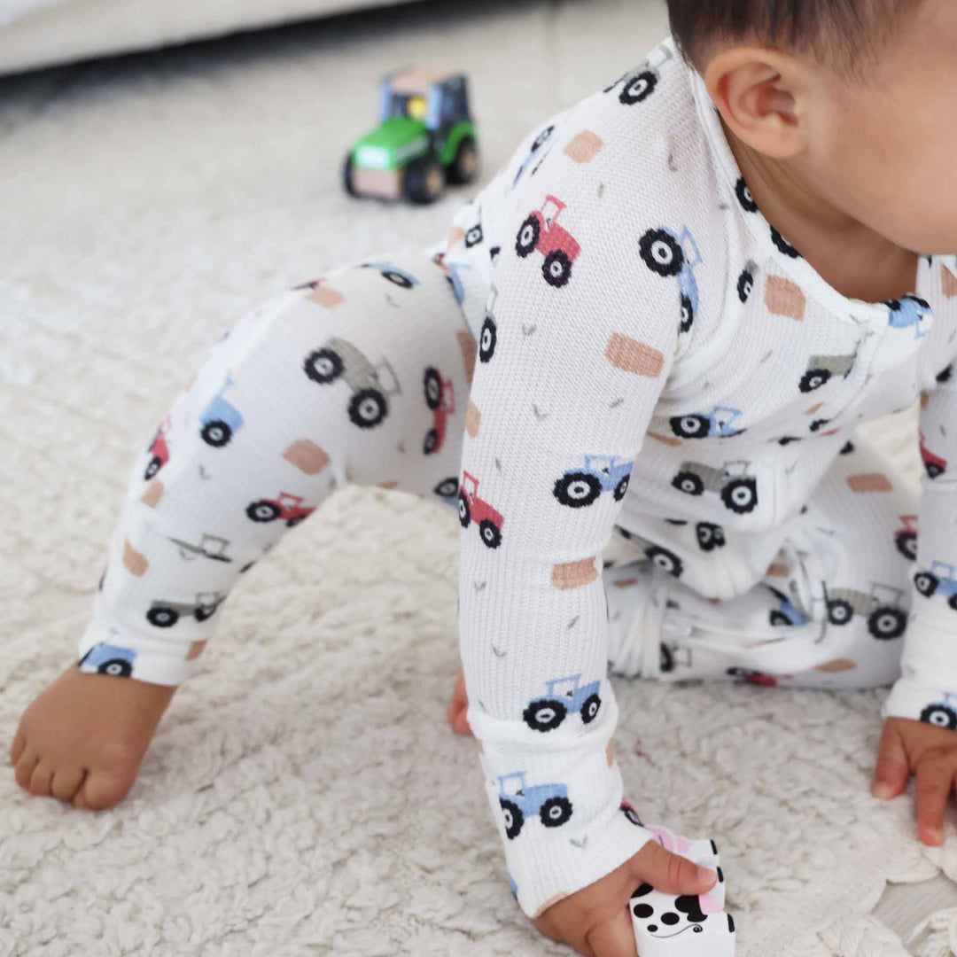 boy wearing tractor bamboo waffle zip romper pajama 