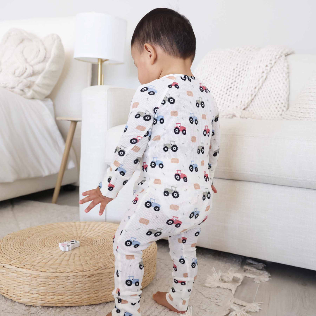 red, green and blue tractor and hay bale pajama romper for baby and toddler boys 