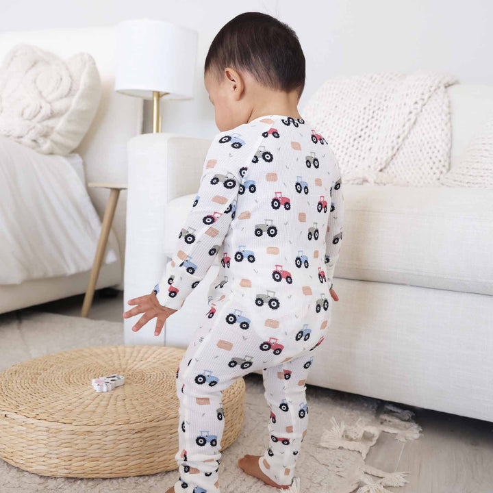 red, green and blue tractor and hay bale pajama romper for baby and toddler boys 