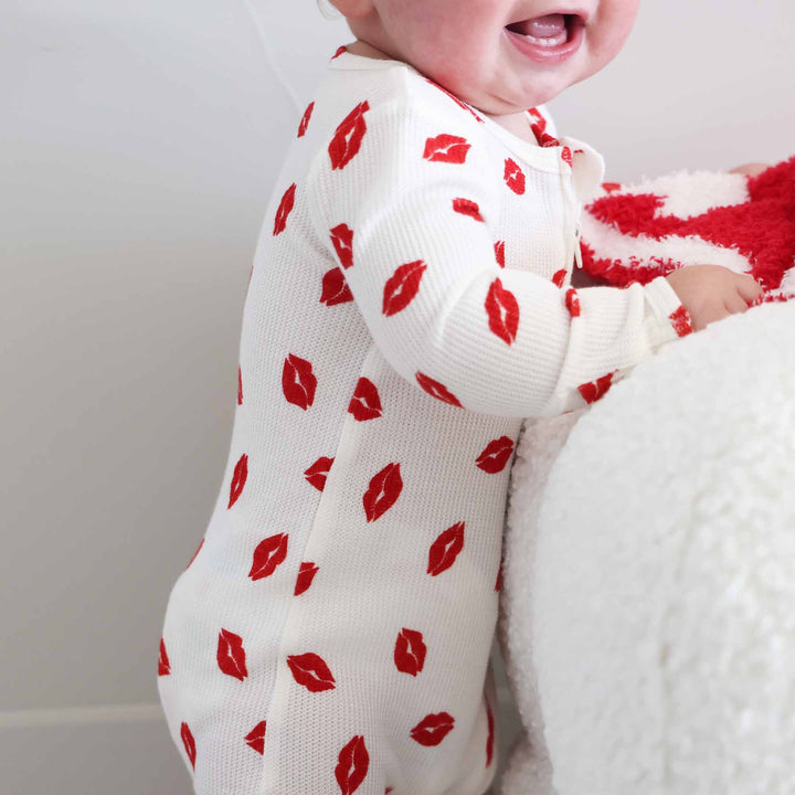 closeup of little kisses bamboo waffle baby footie for valentine's day