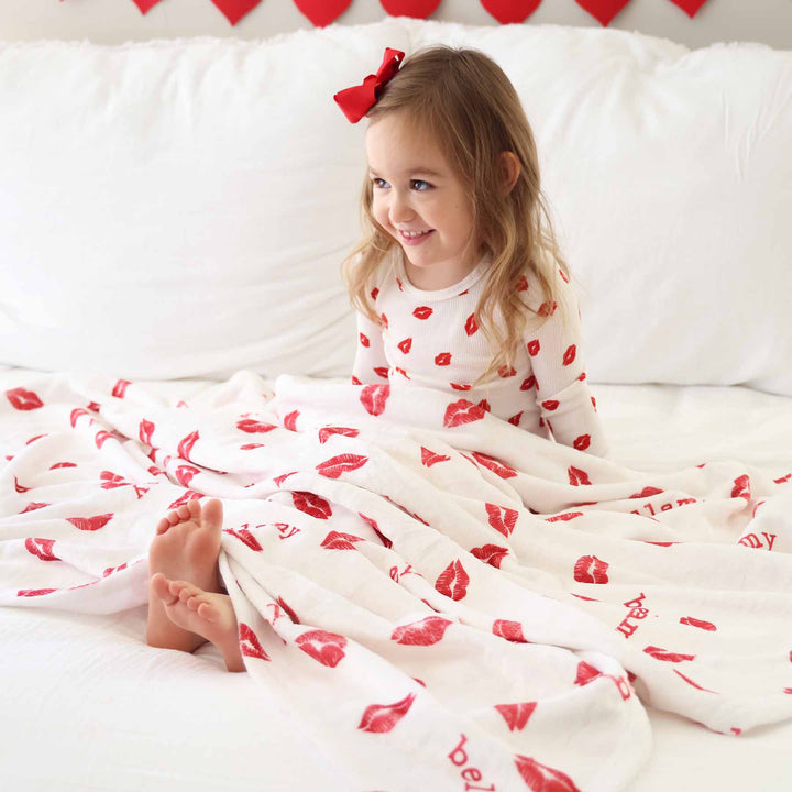 white personalized blanket for kids with red lipstick kisses and personalized name 