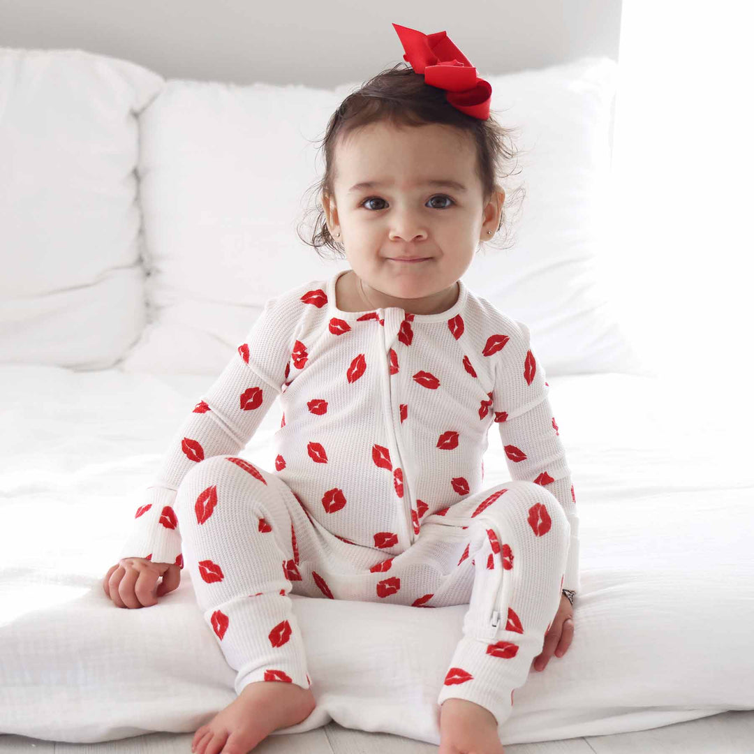 sitting baby girl in red lip convertible zip romper pajama with bamboo waffle fabric 