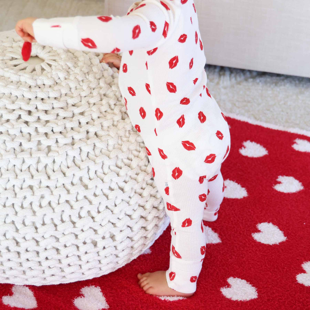 standing baby in red lip convertible zip romper pajama for babies and toddlers 