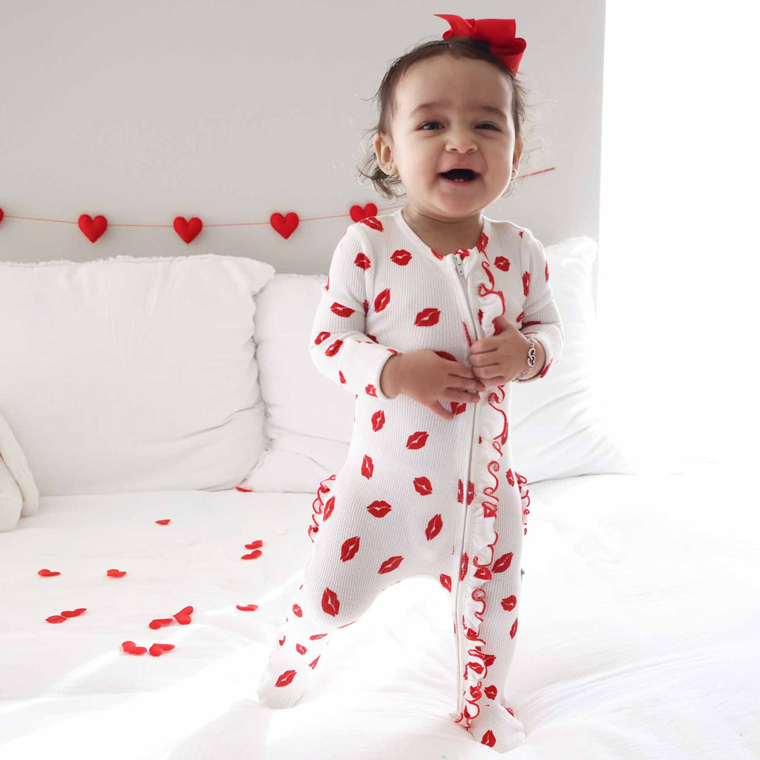 white bamboo waffle ruffle zipper footie with red lipstick kisses