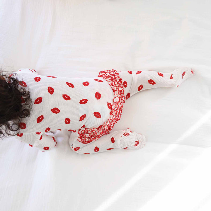 baby girl crawling in a valentine's day kisses bamboo waffle ruffle footie