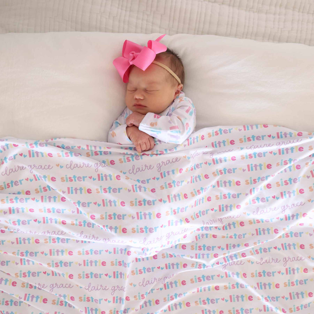 newborn with little sister personalized swaddle