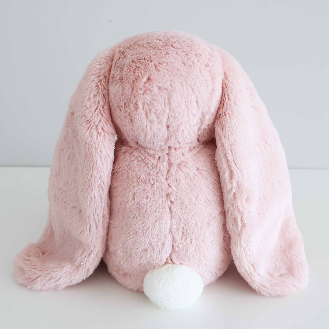 back angle picture of pink bunny stuffed animal with a white tail