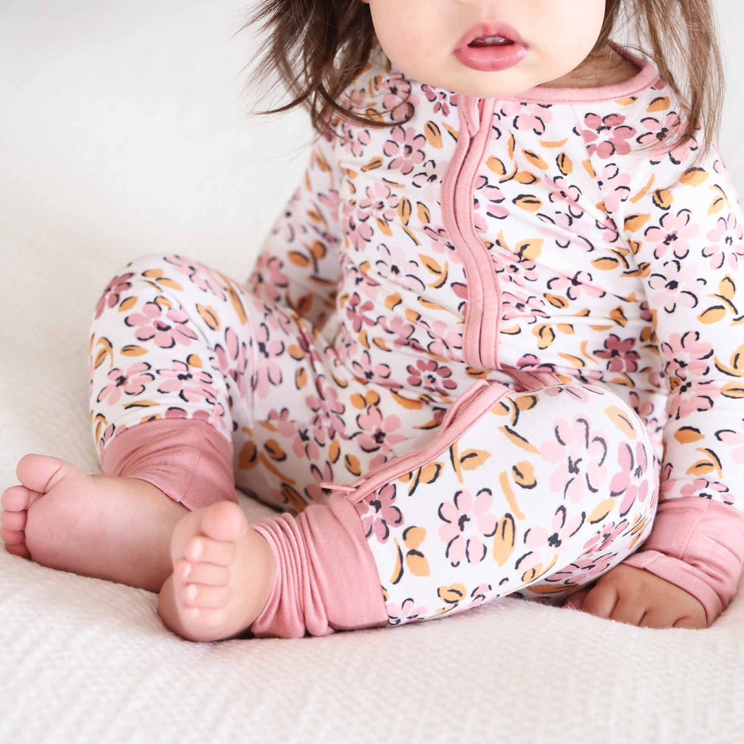 pink and purple floral romper pajama for babies and toddlers with convertible flip mitts and footies 