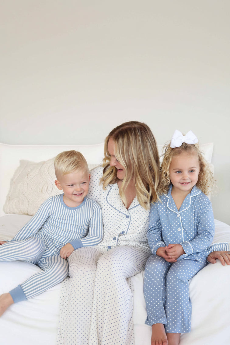 coordinating lounge and pajama sets for mom, daughter and son. dusty blue and white stripe pajama set for boys with polka dot lounge set for mom and daughter in inverted colors. 