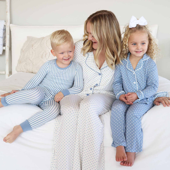 coordinating lounge and pajama sets for mom, daughter and son. dusty blue and white stripe pajama set for boys with polka dot lounge set for mom and daughter in inverted colors. 
