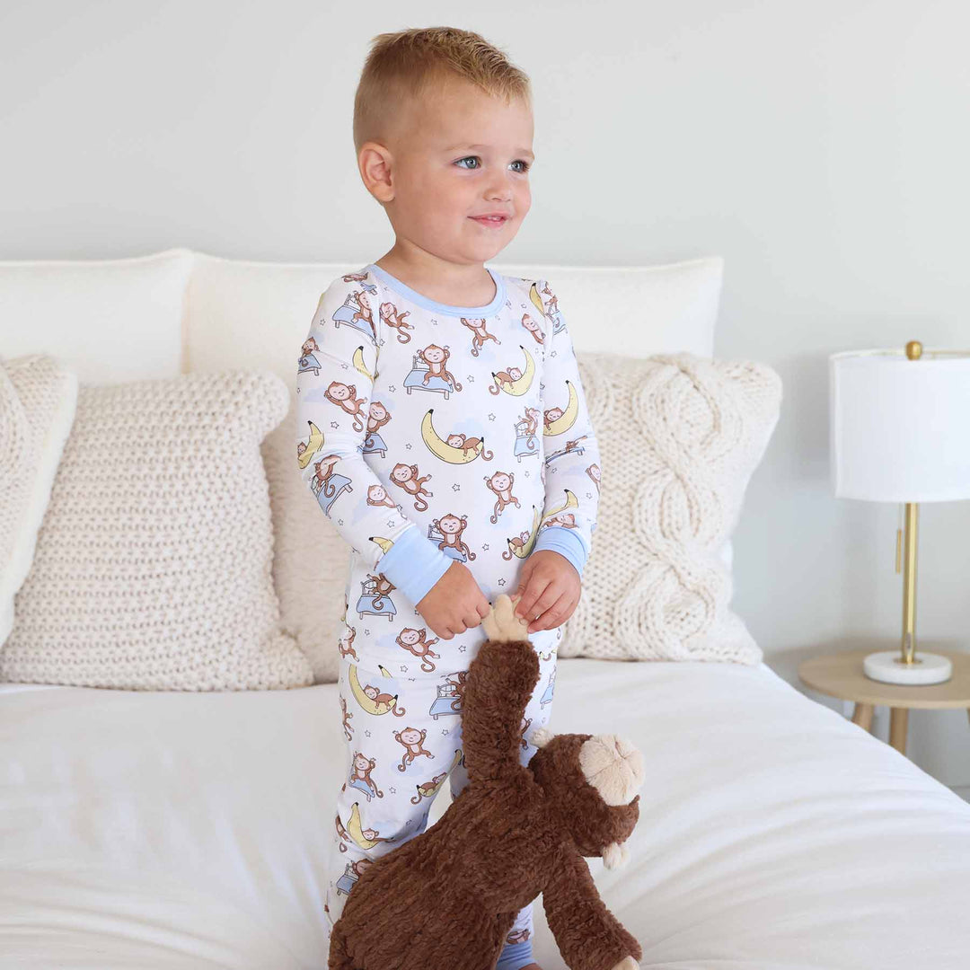 white two piece pajama set for kids with monkeys and bananas 