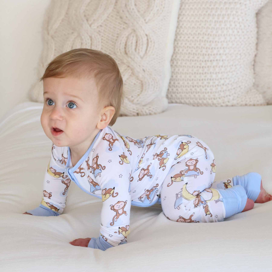 crawling baby in monkey themed pajama romper 